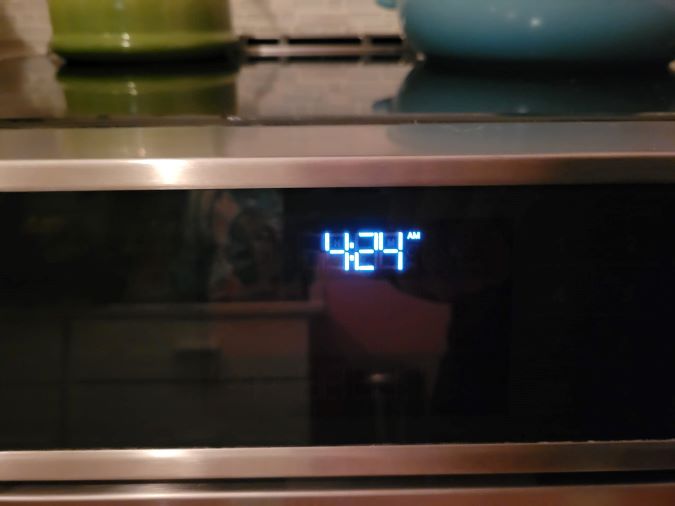 a stove clock reading 4:24 am